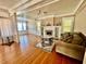Inviting living room with hardwood floors, fireplace, built-in shelving, and comfortable seating creating a cozy ambiance at 236 E Seminole Ave, Lake Wales, FL 33853