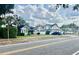 Street view showcasing a charming home with other houses and a parked blue car, capturing a cozy neighborhood atmosphere at 236 E Seminole Ave, Lake Wales, FL 33853