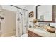 Charming bathroom includes a floral shower curtain, granite countertop, and rustic decor at 242 Kings Pond Sw Ave, Winter Haven, FL 33880