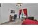 Comfortable bedroom with a desk, chair, and red accents, creating a cozy atmosphere at 242 Kings Pond Sw Ave, Winter Haven, FL 33880