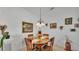 Bright dining room featuring a glass-topped table, four chairs, and neutral wall decor at 242 Kings Pond Sw Ave, Winter Haven, FL 33880