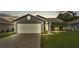 Charming home exterior showcasing a well-manicured lawn, two car garage, and inviting front entrance at 242 Kings Pond Sw Ave, Winter Haven, FL 33880