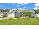 This single-story home offers a well-manicured lawn, two car garage, and clean gray facade at 242 Kings Pond Sw Ave, Winter Haven, FL 33880
