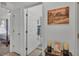 Hallway view leads to a bedroom and bathroom, offering convenient access to private spaces at 242 Kings Pond Sw Ave, Winter Haven, FL 33880