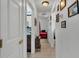 Hallway view leads to a bedroom and bathroom, offering convenient access to private spaces at 242 Kings Pond Sw Ave, Winter Haven, FL 33880
