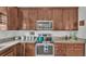 Well-equipped kitchen showcases wood cabinetry, granite counters, and modern appliances, ideal for culinary enthusiasts at 242 Kings Pond Sw Ave, Winter Haven, FL 33880