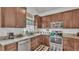 Functional kitchen features ample wood cabinets, granite countertops, and stainless steel appliances for efficient meal preparation at 242 Kings Pond Sw Ave, Winter Haven, FL 33880