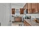 Charming kitchen features wood cabinets, granite countertops, and stainless steel appliances for a modern cooking experience at 242 Kings Pond Sw Ave, Winter Haven, FL 33880