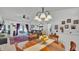 Open-concept living area with dining table, leading to a cozy living space with access to patio at 242 Kings Pond Sw Ave, Winter Haven, FL 33880