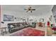Spacious living room boasts a large leather sectional, cozy rug, and adjacent dining area, perfect for entertaining at 242 Kings Pond Sw Ave, Winter Haven, FL 33880