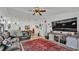 Inviting living room features a leather sofa, ceiling fan, and stylish decor, creating a comfortable gathering space at 242 Kings Pond Sw Ave, Winter Haven, FL 33880