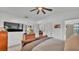 Inviting main bedroom with ceiling fan, TV, and ensuite bathroom access, perfect for relaxation and privacy at 242 Kings Pond Sw Ave, Winter Haven, FL 33880