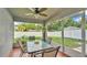 Screened patio featuring a glass table and view of the backyard, perfect for outdoor dining at 242 Kings Pond Sw Ave, Winter Haven, FL 33880