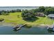 Waterfront property featuring a private boat dock, expansive lawn, and mature trees at 254 Lake Tennessee Dr, Auburndale, FL 33823
