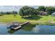 Aerial shot of a home with private dock and boat house on a large lake, surrounded by lush greenery at 254 Lake Tennessee Dr, Auburndale, FL 33823