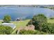 Aerial view of lake, a house, and a private dock, showing a vast expanse of water and surrounding landscape at 254 Lake Tennessee Dr, Auburndale, FL 33823
