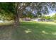 Expansive backyard leading to the lake, showcasing the home and well-maintained lawn at 254 Lake Tennessee Dr, Auburndale, FL 33823