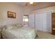 Comfortable bedroom with a bed, closet space, and a view of the hallway at 254 Lake Tennessee Dr, Auburndale, FL 33823