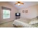 Tranquil bedroom featuring a cozy bed, side window, and wall-mounted TV at 254 Lake Tennessee Dr, Auburndale, FL 33823