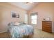 Cozy bedroom featuring a bed, dresser, and window with ample natural light at 254 Lake Tennessee Dr, Auburndale, FL 33823