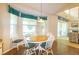 Bright dining area features an oval table with seating for six and sunlit windows at 254 Lake Tennessee Dr, Auburndale, FL 33823