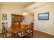 Traditional dining room with wooden table, chandelier, and hutch, filled with natural light and classic decor at 254 Lake Tennessee Dr, Auburndale, FL 33823