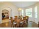 Well-lit dining area with wood table and open access to home office, kitchen and outdoor views at 254 Lake Tennessee Dr, Auburndale, FL 33823