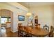 Welcoming dining room with wooden table, elegant lighting, and archways leading to kitchen and staircase at 254 Lake Tennessee Dr, Auburndale, FL 33823