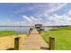 Scenic view of the lake from a wooden dock, perfect for enjoying waterfront living and outdoor recreation at 254 Lake Tennessee Dr, Auburndale, FL 33823