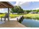 Lake view from a private dock featuring seating and a picturesque home in the background at 254 Lake Tennessee Dr, Auburndale, FL 33823