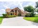 Beautiful two-story home with manicured landscaping, a long driveway, and serene surroundings at 254 Lake Tennessee Dr, Auburndale, FL 33823
