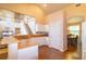 Open kitchen featuring light wood counters and a view of the staircase and the dining room at 254 Lake Tennessee Dr, Auburndale, FL 33823