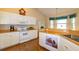 Bright kitchen featuring white cabinets, wood countertops, modern appliances, and a charming breakfast nook at 254 Lake Tennessee Dr, Auburndale, FL 33823