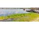 Scenic view of a lake with a boat and a water skier in the distance, and a private dock with a boat slip at 254 Lake Tennessee Dr, Auburndale, FL 33823
