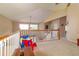Bright loft area featuring a white railing, neutral carpet, and an elevated view overlooking other parts of the home at 254 Lake Tennessee Dr, Auburndale, FL 33823