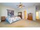 Large main bedroom features a ceiling fan, ample natural light, and plush carpeting at 254 Lake Tennessee Dr, Auburndale, FL 33823