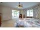 Bright main bedroom featuring floral accents, a sliding glass door, and views of the screened-in lanai at 254 Lake Tennessee Dr, Auburndale, FL 33823