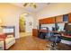 Cozy home office with built-in wooden cabinets and desk, comfortable chair, and view to other rooms at 254 Lake Tennessee Dr, Auburndale, FL 33823