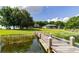 Scenic lakefront view of a home with a private wooden dock on a sunny day at 254 Lake Tennessee Dr, Auburndale, FL 33823