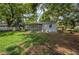 Sprawling backyard featuring lush green grass and mature trees at 315 Eastway Dr, Lakeland, FL 33803