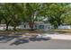 Charming single-story home featuring a well-manicured lawn and inviting curb appeal with mature trees at 315 Eastway Dr, Lakeland, FL 33803