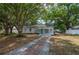 Charming single-story home featuring a well-manicured lawn and inviting curb appeal with mature trees at 315 Eastway Dr, Lakeland, FL 33803