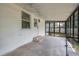 Enclosed patio features concrete flooring and an exterior access door at 315 Eastway Dr, Lakeland, FL 33803