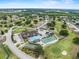 Aerial view of the community, showcasing the clubhouse, pool, tennis courts, and golf course at 3341 Highland Fairways Blvd, Lakeland, FL 33810