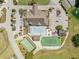 A beautiful aerial view of a clubhouse, swimming pool, tennis court, and parking for recreational activities at 3341 Highland Fairways Blvd, Lakeland, FL 33810