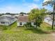 Enjoy the beautiful backyard with a lush green lawn, palm trees, and mature trees at 3341 Highland Fairways Blvd, Lakeland, FL 33810