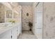 This primary bath has a tub/shower combo, dual sinks, decorative wallpaper, and updated vanity at 3341 Highland Fairways Blvd, Lakeland, FL 33810