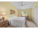 Bright bedroom with a comfortable bed, ceiling fan, neutral carpet, and a sunny window at 3341 Highland Fairways Blvd, Lakeland, FL 33810