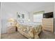 This bedroom features carpet, lamps, a chest of drawers, and a sunny window at 3341 Highland Fairways Blvd, Lakeland, FL 33810