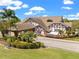 A gorgeous clubhouse with palm trees and lush foliage in a prime location within the community at 3341 Highland Fairways Blvd, Lakeland, FL 33810
